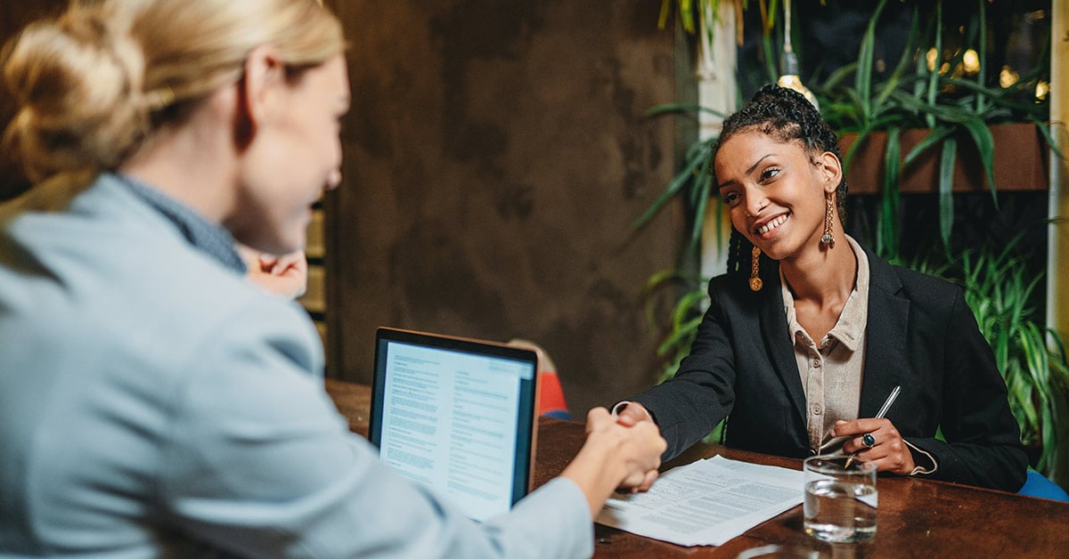 Small business owner shaking hands with banker