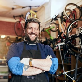 Small business owner in front of financed equipment