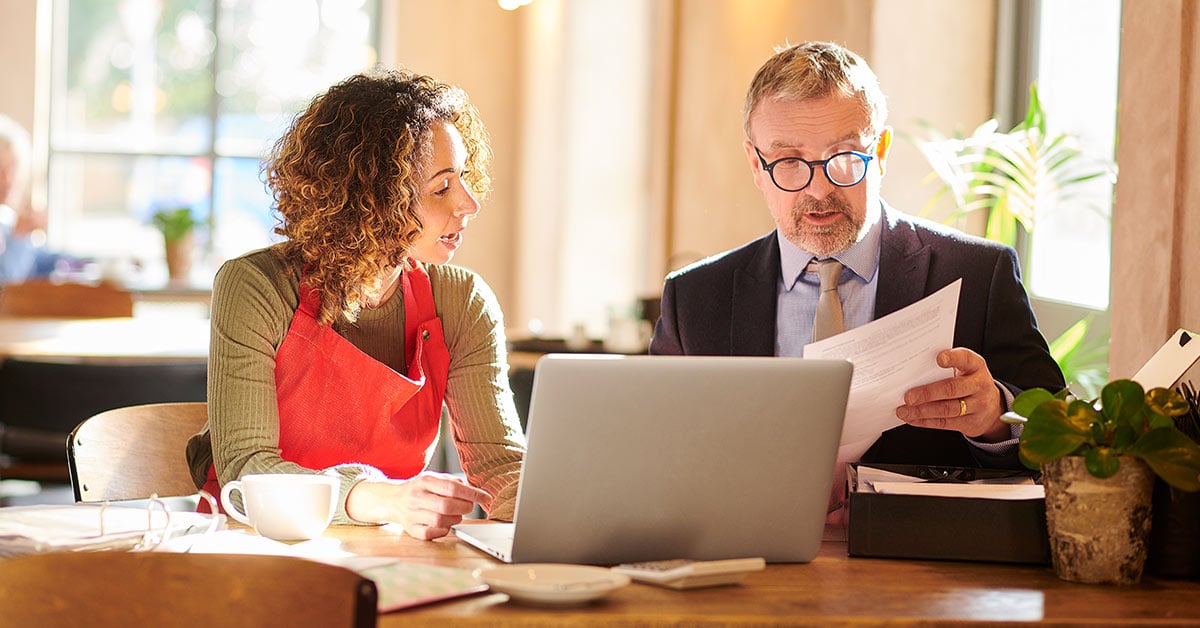 Small business owner collaborating with equipment finance lender