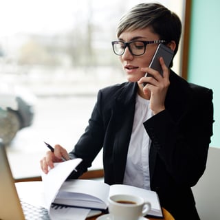 Small business owner speaking on the phone with Stearns Bank's team