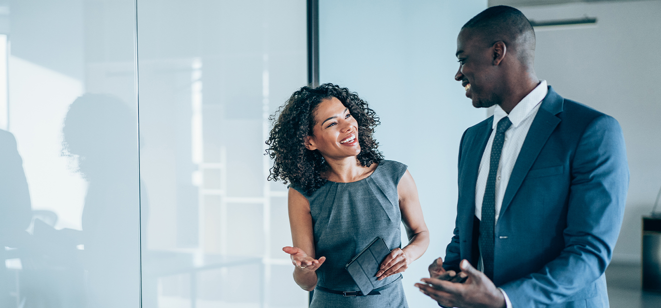 Male and female business owners conversing